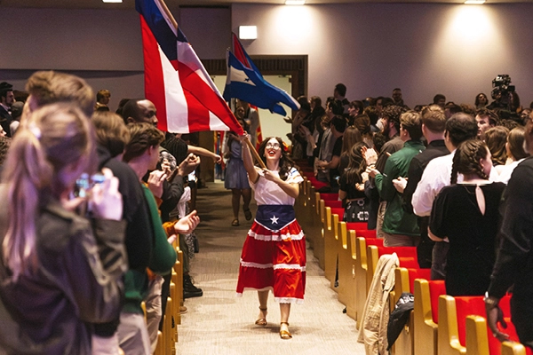 An international student carries the Puerto Rican flag at Missions Conference, a student conference from Moody Conferences
